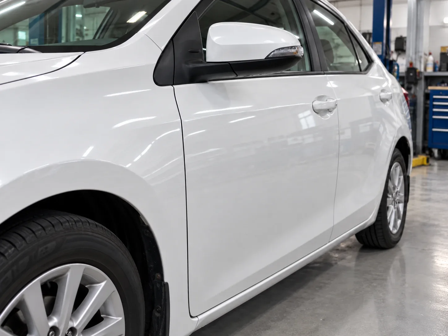 Toyota Corolla front driver-side door after paintless dent repair with dent completely removed